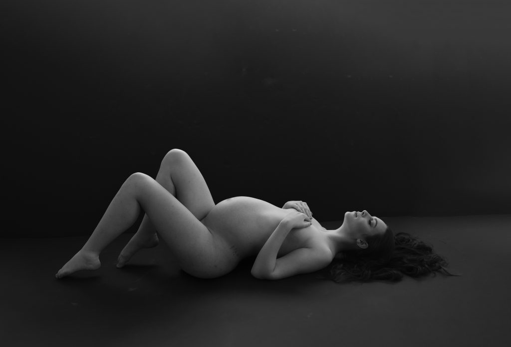 full nude fine art maternity naked woman laying down pregnant