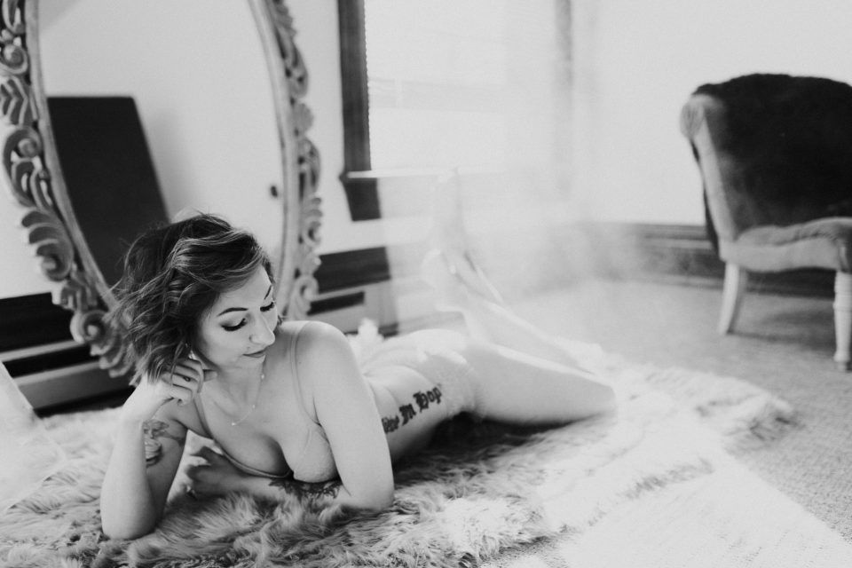 girl laughing feeling gorgeous and sensual in boudoir photo