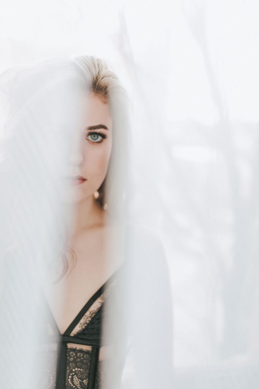 looking through curtains soft green eyes blonde