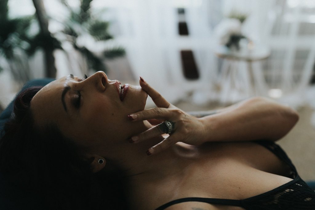 woman laying down touching face sensual