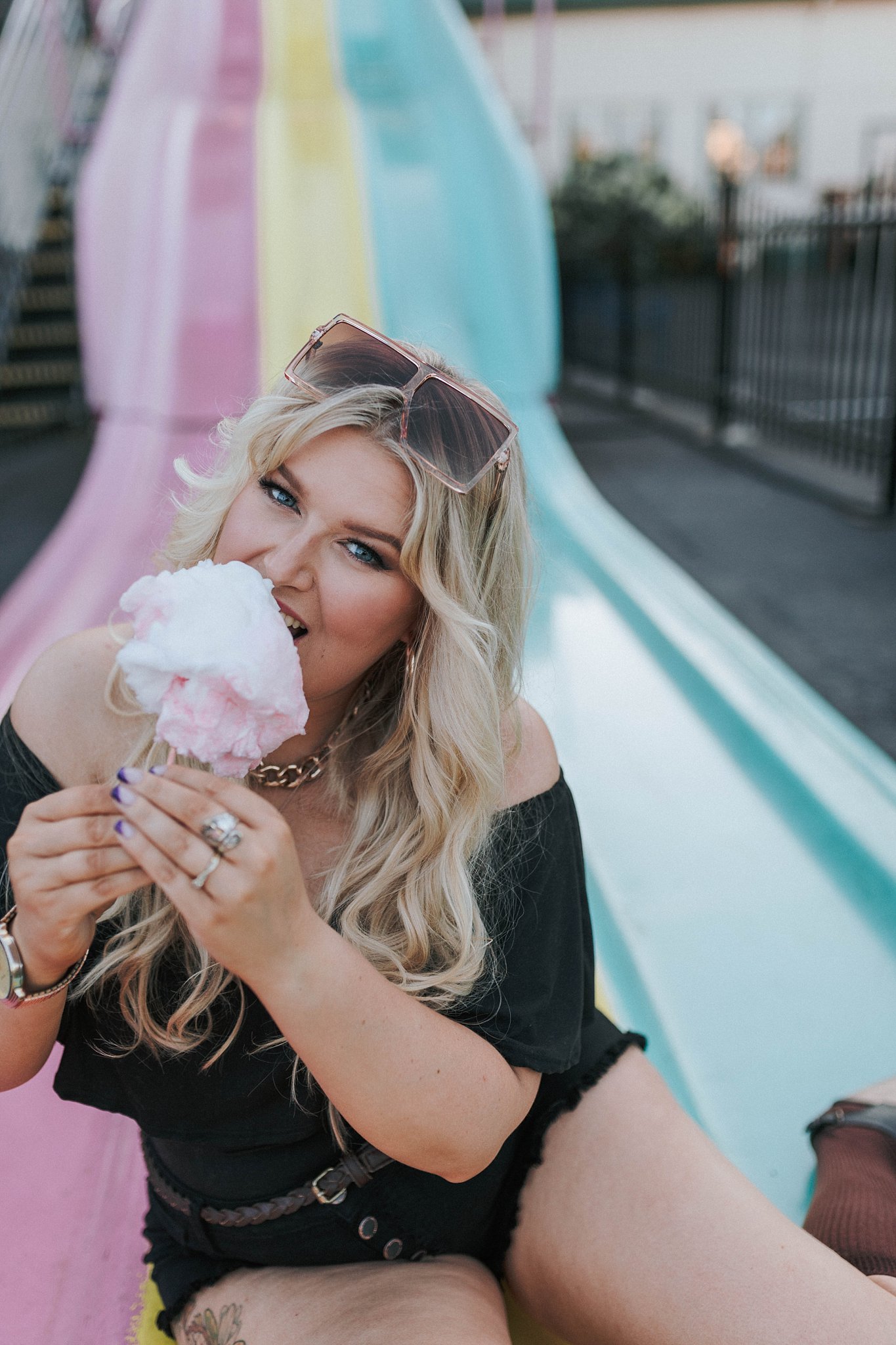 blonde eating cotton candy amusement park